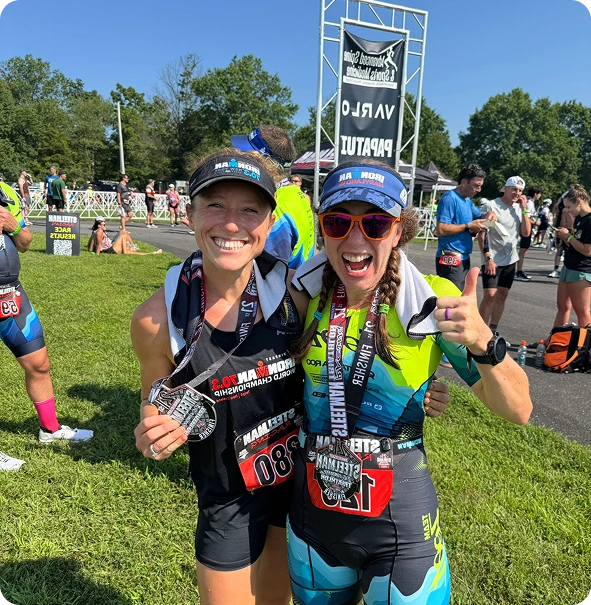 Two triathletes celebrating after a race