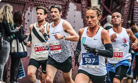 Coach Megan Pappalardo running in a road race