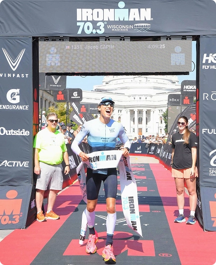 Triathlete crossing the Ironman 70.3 finish line